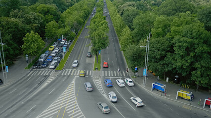 Sky tower overhead view of metropolitan boulevard with cars passing on streets, nature and...