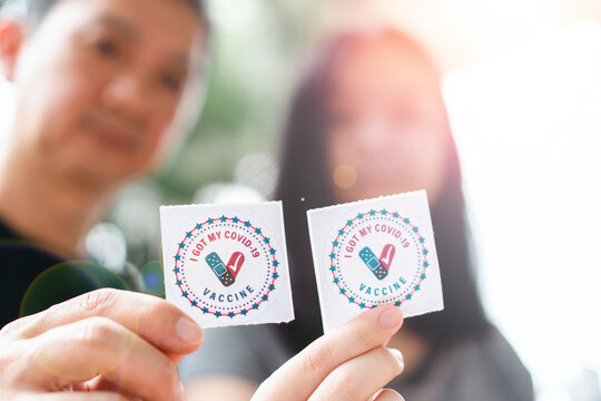 Sticker “I Got My Covid-19 Vaccine” In Hand Of Family With Nature Bokeh Background As Vaccination Protect From Coronavirus.