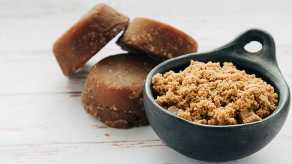 panela, from sugar cane, for different preparations on a white wooden base, made in Colombia.