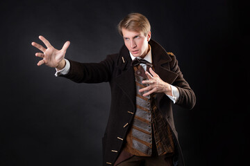 character of the steampunk story, a young attractive man in an elegant long coat