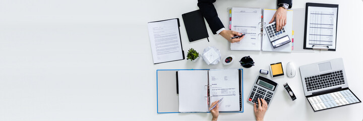 Two Businesspeople Calculating Bills In Office