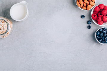 Healthy breakfast. Ingredients for oatmeal. Blueberries, strawberries, almonds, milk and oats.
