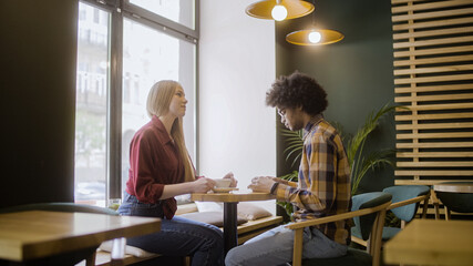 Upset young man and woman sitting in cafe, couple having fight, relationship crisis