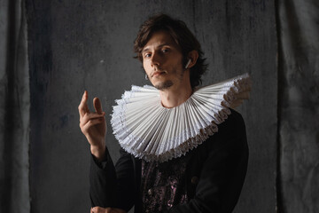 Classics are eternal, art is timeless. A young man in a medieval collar and suit