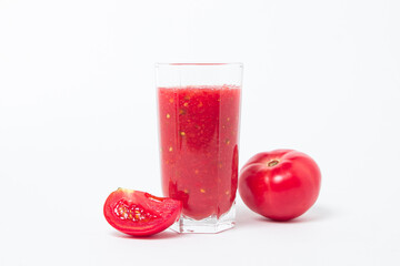 A glass of tomato juice on a white background. Natural freshly squeezed tomato juice.