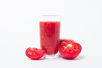A glass of tomato juice on a white background. Natural freshly squeezed tomato juice.