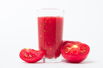 A glass of tomato juice on a white background. Natural freshly squeezed tomato juice.
