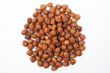 Peeled hazelnuts on a white background. Healthy diet