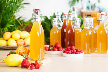 fermented drink, kombucha in glass bottle with with fruits and Berries