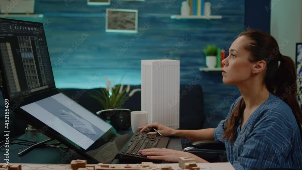 Poster invalid architect using touch screen for building layout in engineering office. woman engineer sitti