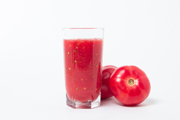 A glass of tomato juice on a white background. Natural freshly squeezed tomato juice.