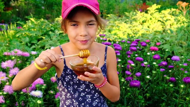 The child eats homemade honey. Selective focus.