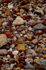 Various warm colored rocks on the beach