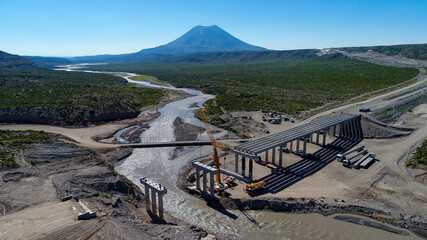 Aerial view of the construction of a new bridge over a river in Latin America.
