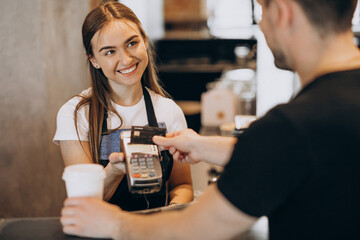Customer paying with card in a coffee house