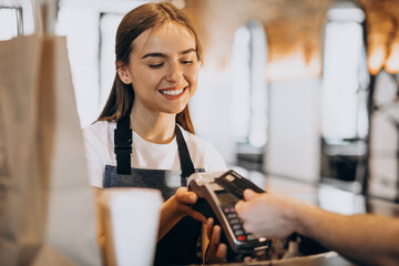 Customer paying with card in a coffee house