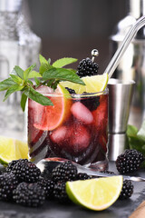  Blackberry summer mojito cocktail. Cold refreshing organic alcoholic drink with berries, lime, mint