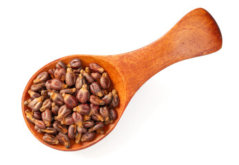 Dried grape seeds in the wooden spoon, isolated on white background, top view