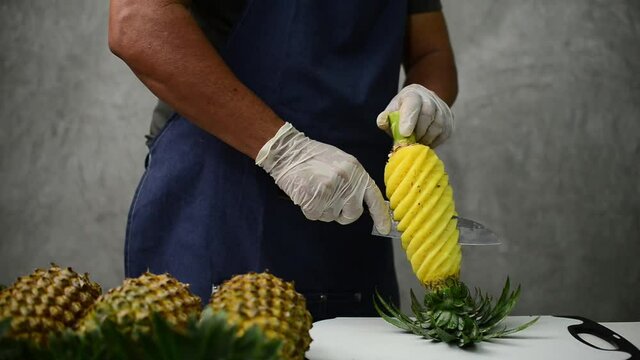 
Experts use sharp knives and tools to peel and gouge the pineapple out beautifully