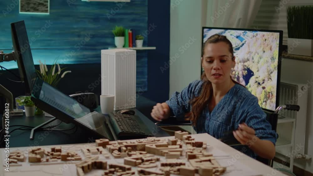 Poster disabled architect working on construction layout at office. woman with handicap sitting in wheelcha