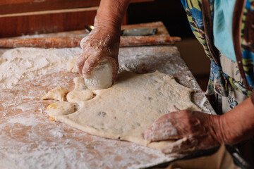 person kneading dough