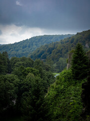 A mountain panorama from Ojcow Castle, Polish Jura, Poland. Dense forest, storm clouds. Moody, rainy day. 