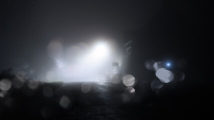 A mysterious building by street lights on a misty winters night. With a blurred, bokeh, out of focus edit
