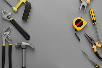 Flat lay composition with construction and home repair tools tools on grey background, space for...