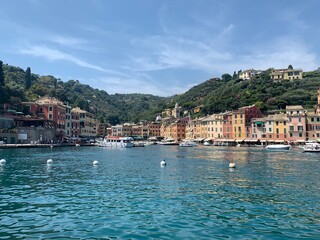 Fototapeta na wymiar Skyline of Portofino village with colourful houses and emerald water. It is famous holiday resort and fishing Italian riviera town. Portofino, Italy