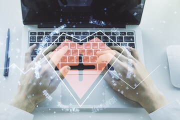 Double exposure of creative abstract heart rate hologram and hands typing on laptop on background. Healthcare technolody concept