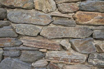 Wall of irregular stones aged. Vintage horizontal background