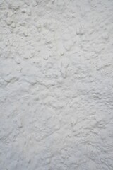 Aged, rough, white wall. Vertical Background