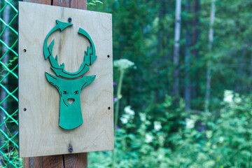 Sign with a creative symbol of recycling in the park on a forest background