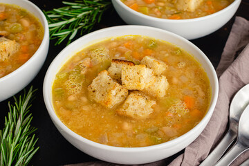 Creamy White Bean Soup with Rosemary and Pancetta: Bowls of cannellini bean soup made with vegetables, rosemary, and pancetta
