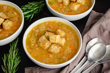 Creamy White Bean Soup with Rosemary and Pancetta: Bowls of cannellini bean soup made with vegetables, rosemary, and pancetta