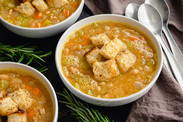 Creamy White Bean Soup with Rosemary and Pancetta: Bowls of cannellini bean soup made with vegetables, rosemary, and pancetta