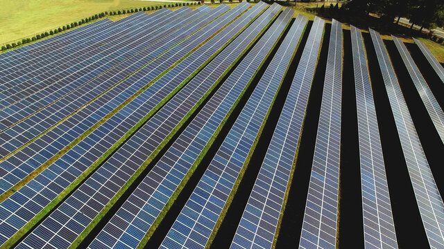 Drone high angle view of solar energy photovoltaic PV panels background.