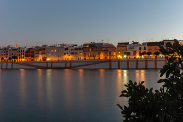 City lights reflecting in the river at night | Seville, Spain