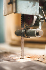 Close-up detail of automatic fixed electric jigsaw in carpentry workshop