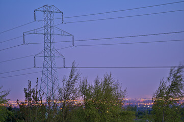 Obraz premium Beautiful early morning view of power lines with electricity transmission pylon against epic sky before sunrise in Ticknock Forest National Park, County Dublin, Ireland. Soft and selective focus