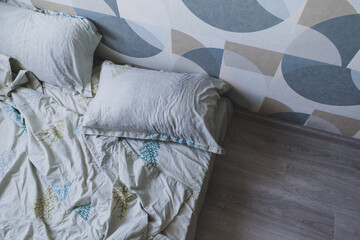 White pillows, duvet and duvet case on a bed. White bed linen. Bedroom with bed and bedding. 