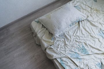 Fototapeta na wymiar White pillows, duvet and duvet case on a bed. White bed linen. Bedroom with bed and bedding. 