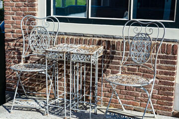 Vintage metal bistro table and chairs set in outdoor cafe