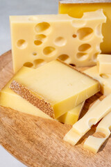 Cheese collection, hard French cheeses comte and emmentaler with round holes made from cow milk