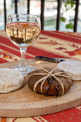Tastes of Provence, ancient small goat cheese Banon a la feuille wrapped in chestnut leaves and tied with raffia and Tome de Provence served with rose wine