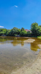 Landscape with a lake and clouds in the sky in the summer season