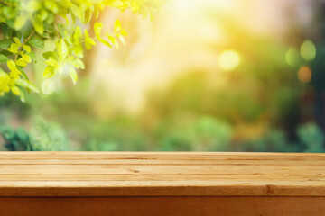 Empty wooden  table over blurred nature background.  Outdoor picnic mock up for design and product...