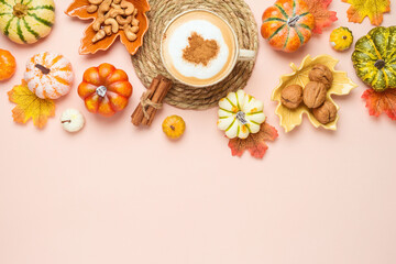 Fototapeta na wymiar Autumn season concept with coffee cup, pumpkin and fall leaves on wooden table background