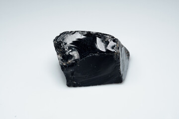 Natural black obsidian stone on white background