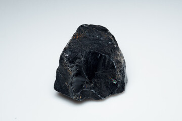 Obraz premium Natural black obsidian stone on white background